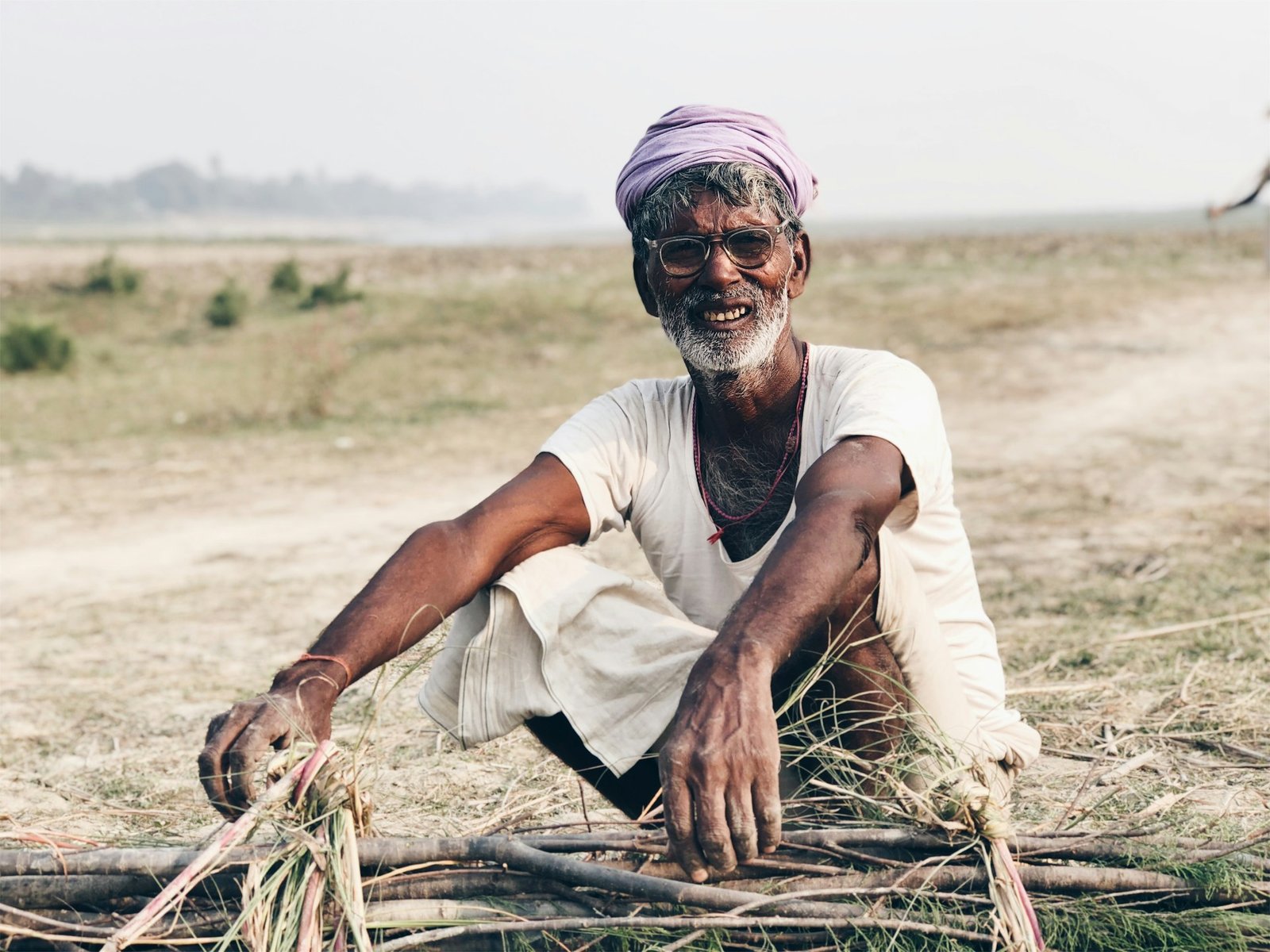 Smiling farmer in Bangladesh holding fresh produce